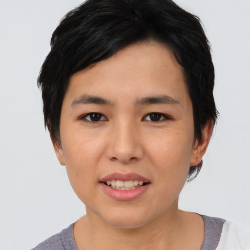 Joyful asian young-adult female with short  black hair and brown eyes