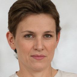 Joyful white adult female with short  brown hair and green eyes