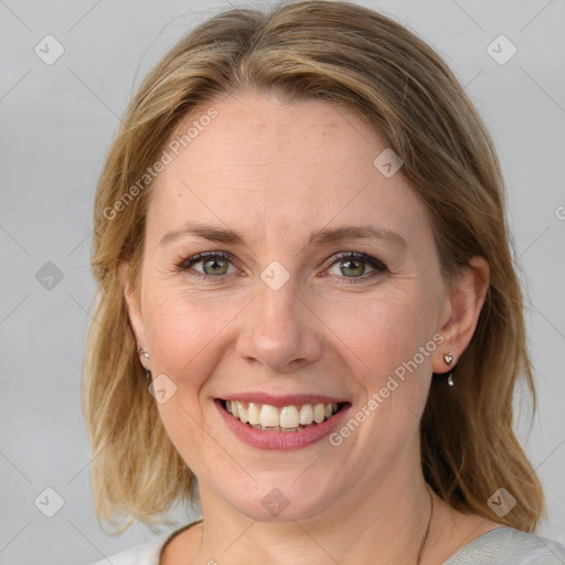 Joyful white adult female with medium  brown hair and blue eyes