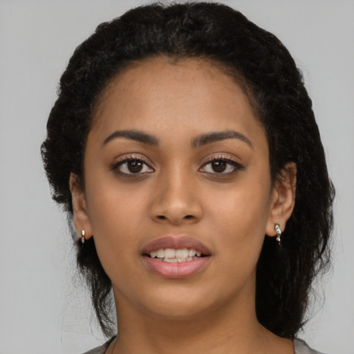 Joyful latino young-adult female with long  black hair and brown eyes