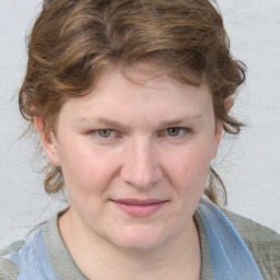 Joyful white young-adult female with medium  brown hair and blue eyes