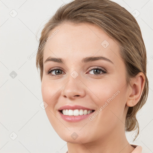 Joyful white young-adult female with medium  brown hair and green eyes