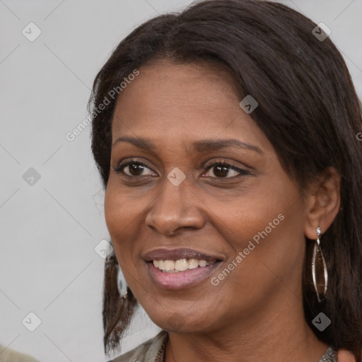 Joyful black adult female with medium  brown hair and brown eyes