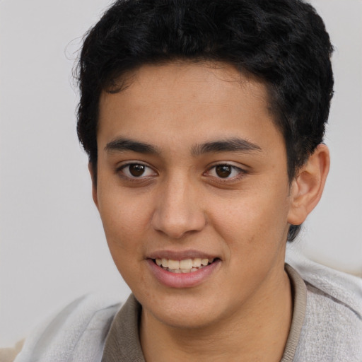 Joyful latino young-adult male with short  brown hair and brown eyes