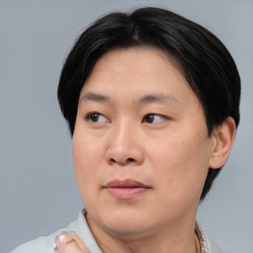 Joyful asian adult male with short  black hair and brown eyes