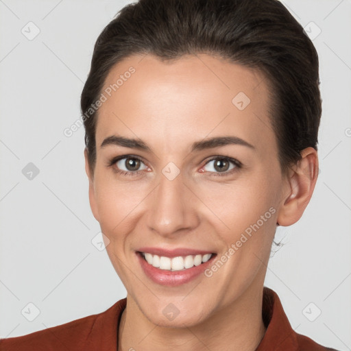 Joyful white young-adult female with short  brown hair and brown eyes