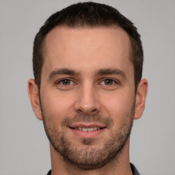 Joyful white young-adult male with short  brown hair and brown eyes