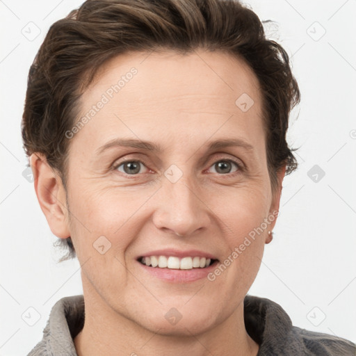 Joyful white adult female with short  brown hair and grey eyes