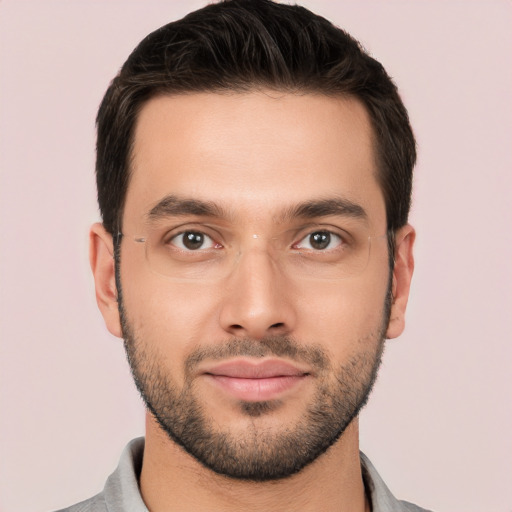 Joyful white young-adult male with short  black hair and brown eyes