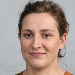 Joyful white adult female with medium  brown hair and brown eyes