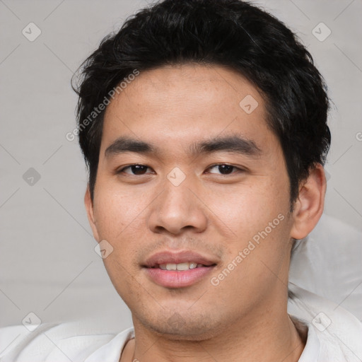 Joyful asian young-adult male with short  black hair and brown eyes