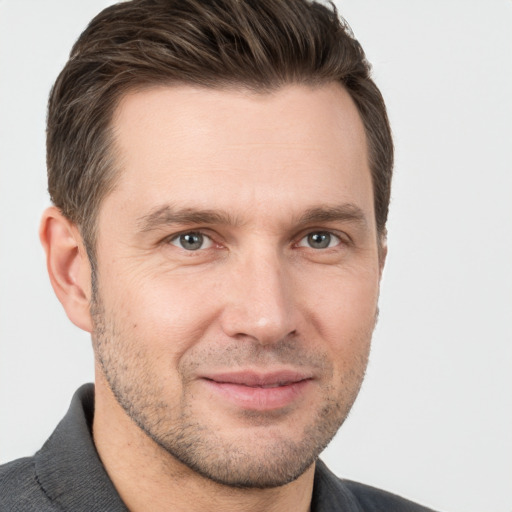 Joyful white adult male with short  brown hair and brown eyes