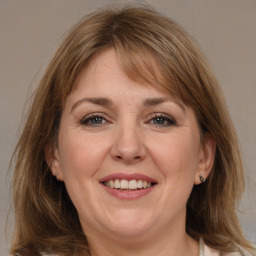 Joyful white adult female with medium  brown hair and grey eyes