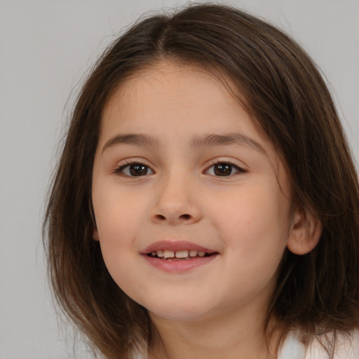 Joyful white child female with medium  brown hair and brown eyes