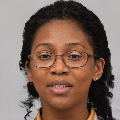 Joyful black adult female with medium  brown hair and brown eyes