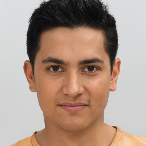 Joyful latino young-adult male with short  black hair and brown eyes