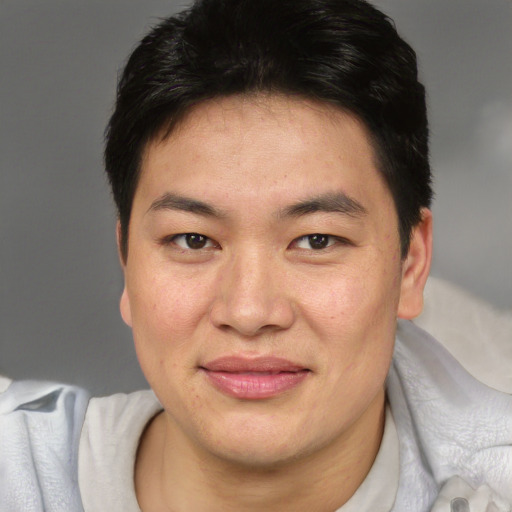 Joyful asian young-adult female with short  brown hair and brown eyes