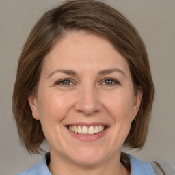 Joyful white adult female with medium  brown hair and brown eyes