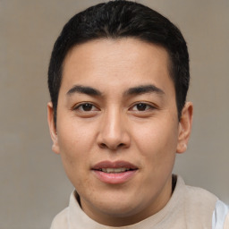 Joyful latino young-adult male with short  brown hair and brown eyes