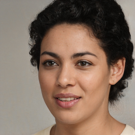 Joyful black young-adult female with medium  black hair and brown eyes