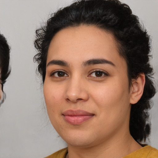 Joyful latino young-adult female with medium  black hair and brown eyes