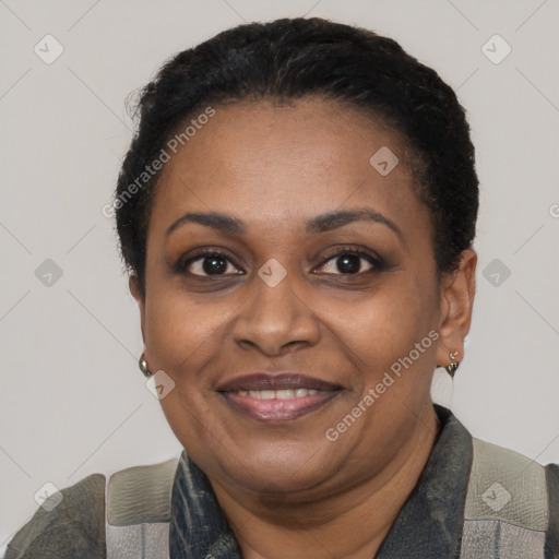 Joyful black adult female with short  black hair and brown eyes