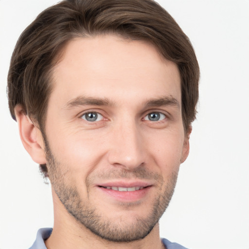 Joyful white young-adult male with short  brown hair and grey eyes