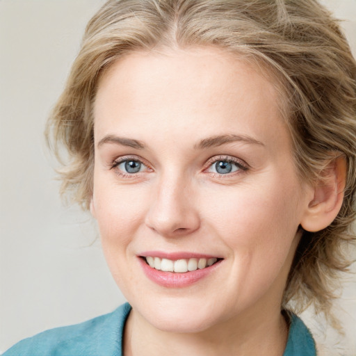 Joyful white young-adult female with medium  brown hair and blue eyes