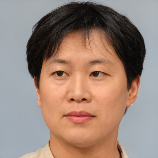 Joyful asian adult female with short  brown hair and brown eyes