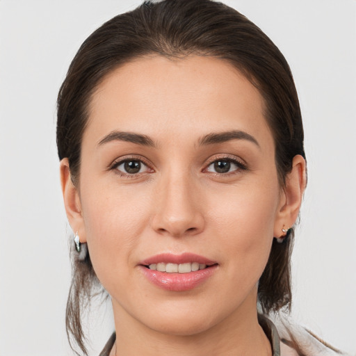 Joyful white young-adult female with medium  brown hair and brown eyes