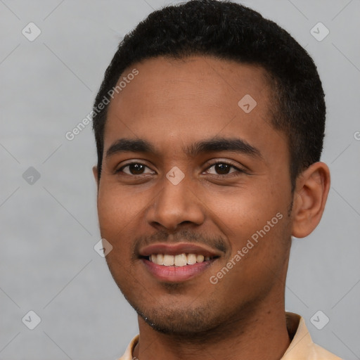 Joyful black young-adult male with short  brown hair and brown eyes