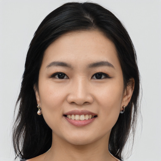 Joyful asian young-adult female with long  black hair and brown eyes