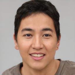 Joyful asian young-adult male with short  brown hair and brown eyes