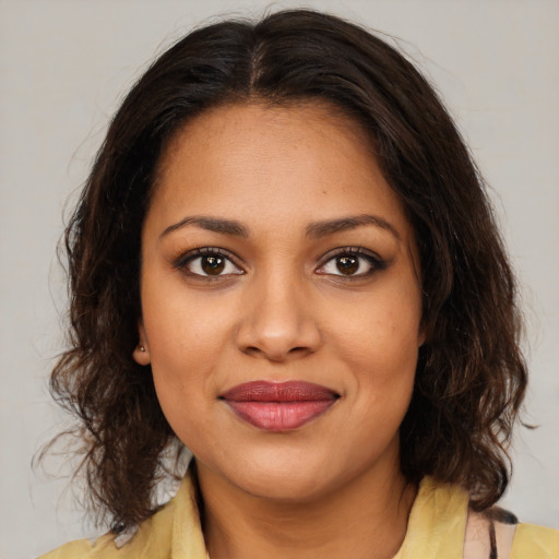 Joyful black young-adult female with medium  brown hair and brown eyes