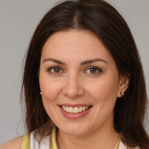 Joyful white young-adult female with medium  brown hair and brown eyes