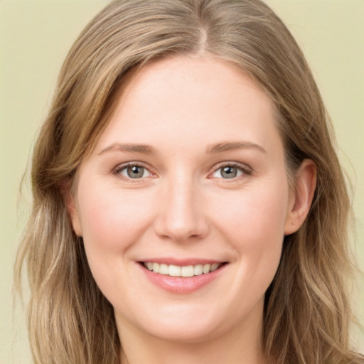 Joyful white young-adult female with long  brown hair and green eyes