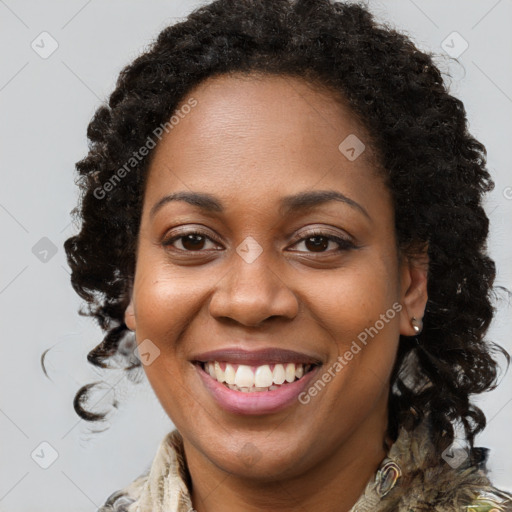 Joyful black young-adult female with long  brown hair and brown eyes