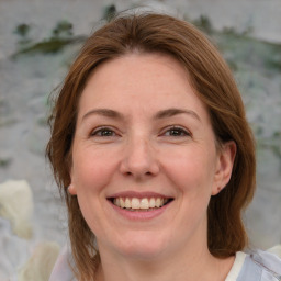 Joyful white adult female with medium  brown hair and blue eyes