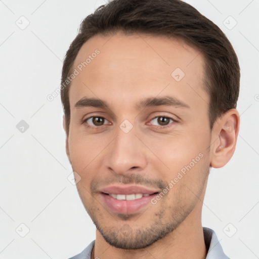 Joyful white young-adult male with short  brown hair and brown eyes