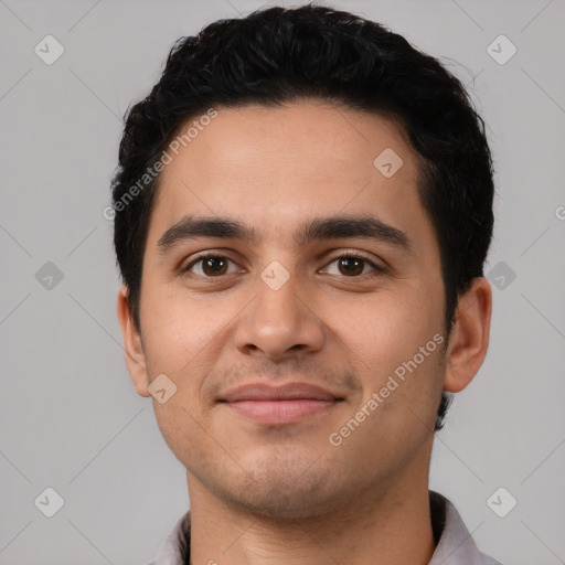 Joyful latino young-adult male with short  black hair and brown eyes