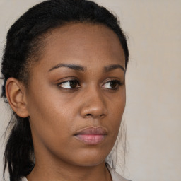 Neutral black young-adult female with medium  brown hair and brown eyes