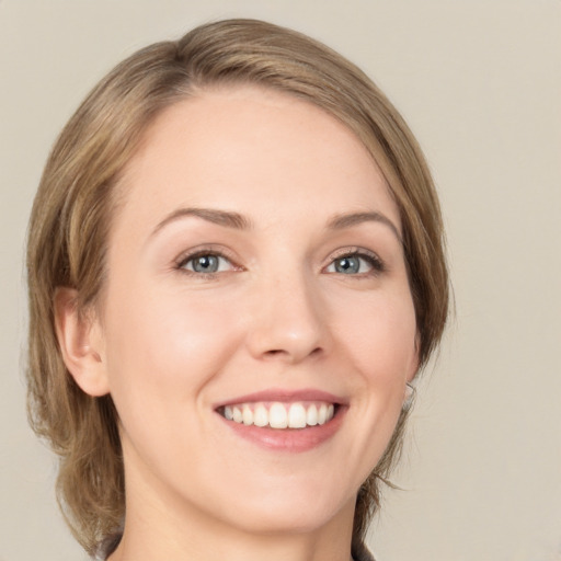 Joyful white young-adult female with medium  brown hair and green eyes