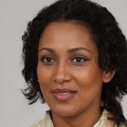 Joyful black adult female with medium  brown hair and brown eyes