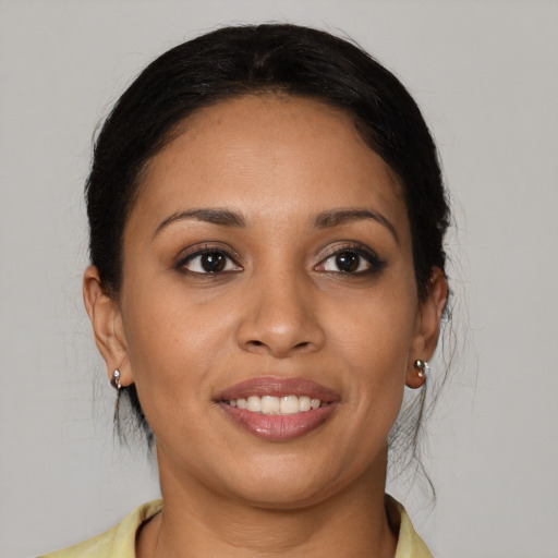 Joyful latino young-adult female with medium  brown hair and brown eyes