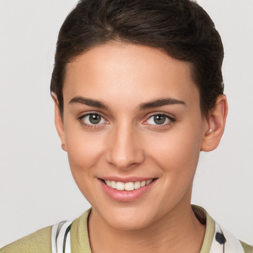 Joyful white young-adult female with short  brown hair and brown eyes