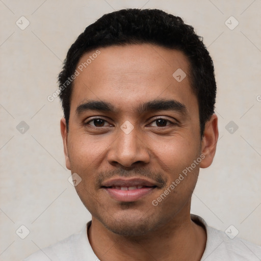 Joyful latino young-adult male with short  black hair and brown eyes