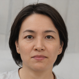 Joyful white adult female with medium  brown hair and brown eyes