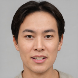 Joyful asian young-adult male with short  brown hair and brown eyes