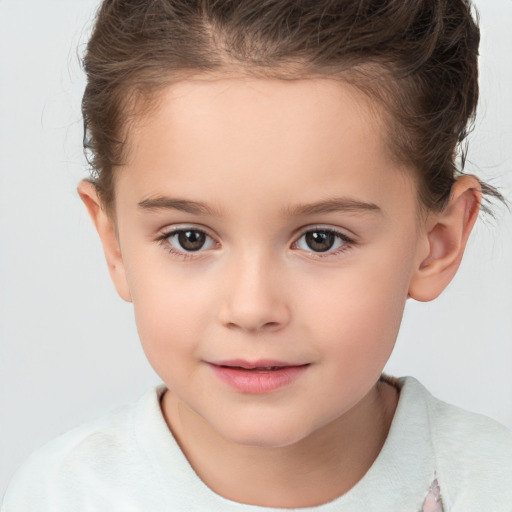 Joyful white child female with short  brown hair and brown eyes