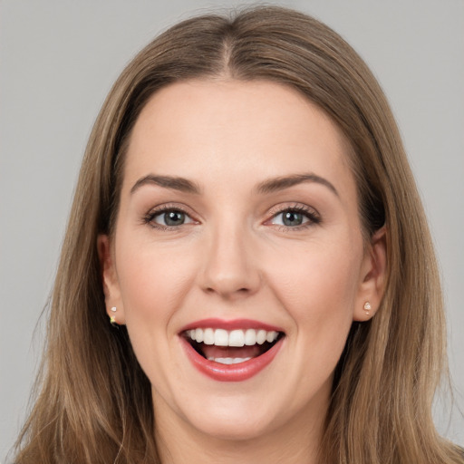 Joyful white young-adult female with long  brown hair and brown eyes